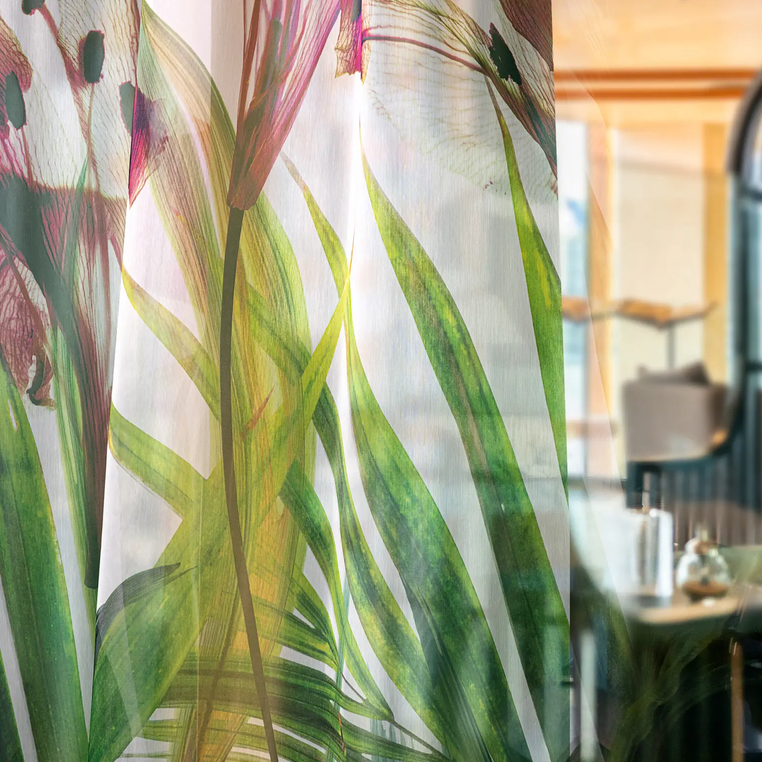 Digitally printed Vescom Chira sheer curtain, printed with a tropical floral pattern and a matte, woven look.