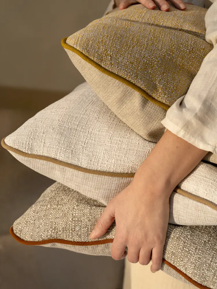 Laguna& Bay upholstery fabric by Vescom on cushions with fine two-tone woven texture with person