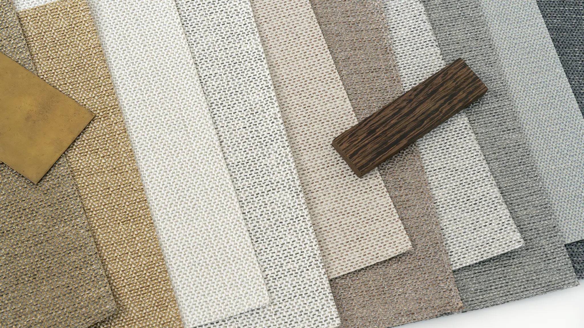 Vescom Amber woven textile wallcovering colour range showing pronounced weave texture with brass and wood samples